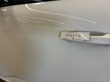a sticker on the door handle of a white car