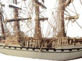 a model of a ship on display on a white surface