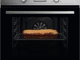 an oven with a loaf of bread in it sitting inside of it