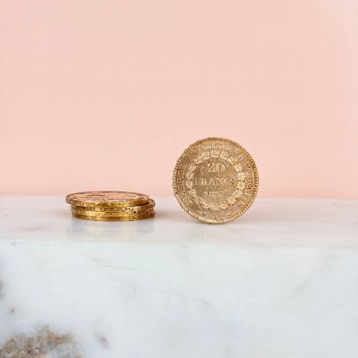 a close up of a gold coin sitting on top of a marble counter