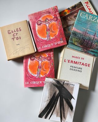 several books are stacked on top of each other on a table