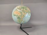 a small blue and green globe on a stand