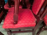 a red chair that has a red cushion on it