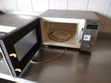 a microwave that is sitting on a counter in a kitchen