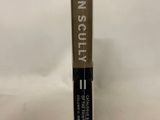 a close up of a tube of mascara on a white background