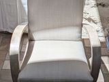 a white chair that is sitting on a tile floor