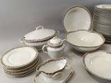 a lot of plates and bowls that are on the table