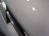 a close up of a door handle on a white refrigerator