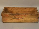 an old wooden crate sitting on top of a white table