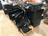 a pile of computer equipment on a pallet in a warehouse