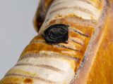 a close up of a statue of a horse with a wax seal on it ' s nose
