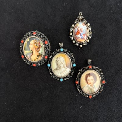 four miniature portraits of people are displayed on a black surface