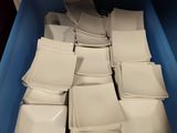 a lot of white plates in a blue container