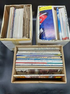 two boxes filled with books sitting on top of a table