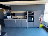a picture of a kitchen with a sink and a microwave