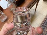 a person holding a glass of water in their hand