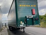 a green truck that is driving down the road