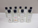 six bottles of cologne sitting on top of a white table
