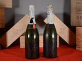 two bottles of wine sitting on a red table cloth