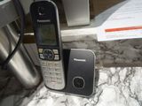 a phone that is sitting on a table next to a cup