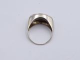 a close up of a silver ring on a white surface