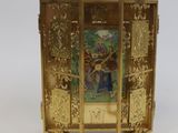 a gold clock with a picture of a man on it