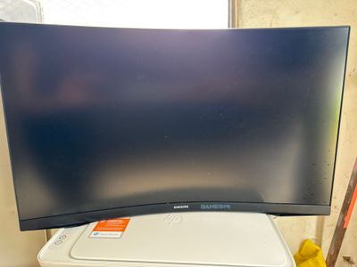 a large flat screen tv sitting on top of a trash can