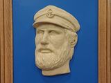 tableau dans un cadre en bois représentant un homme barbu portant un chapeau