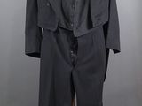 an image of a black suit and tie on a mannequin