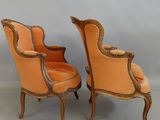 two orange chairs with gold trims on them against a white background