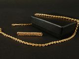 a black box with a chain around it and a gold chain