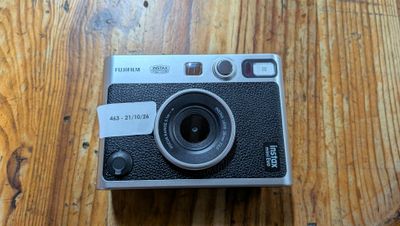 a camera sitting on a wooden table on a table