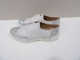 white leather shoes with silver glitters on them on a white surface