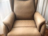 a reclining chair in the corner of a room