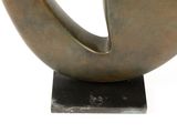 bronze sculpture of a circular shape on a black base