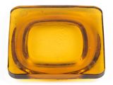 yellow glass square bowl with a brown rim on a white surface