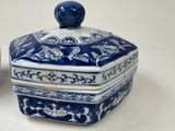 a blue and white box with a lid on a table