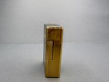 a gold lighter that is sitting on a table