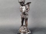 statue of a boy holding a bird on a pedestal