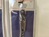 four different types of scissors on display on the wall