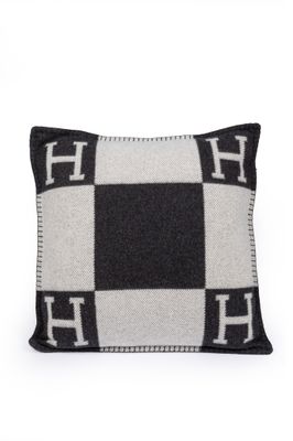 a black and white checkered pillow with the letter h on it