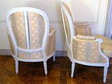 two chairs sitting next to each other on a wooden floor