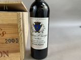a bottle of wine sitting next to a wooden box