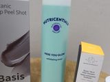 a bottle of lotion, a box of cream, and a box of cream on a table