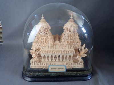 une petite maquette d'un bâtiment sous un dôme de verre