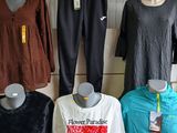 several mannequins are lined up on a shelf in a clothing store