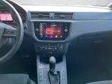 the interior of a car with a steering wheel and dashboard controls