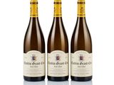 three bottles of wine sitting next to each other on a white surface
