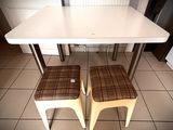 two stools sitting next to a table in a kitchen