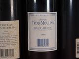 several bottles of wine are lined up on a shelf